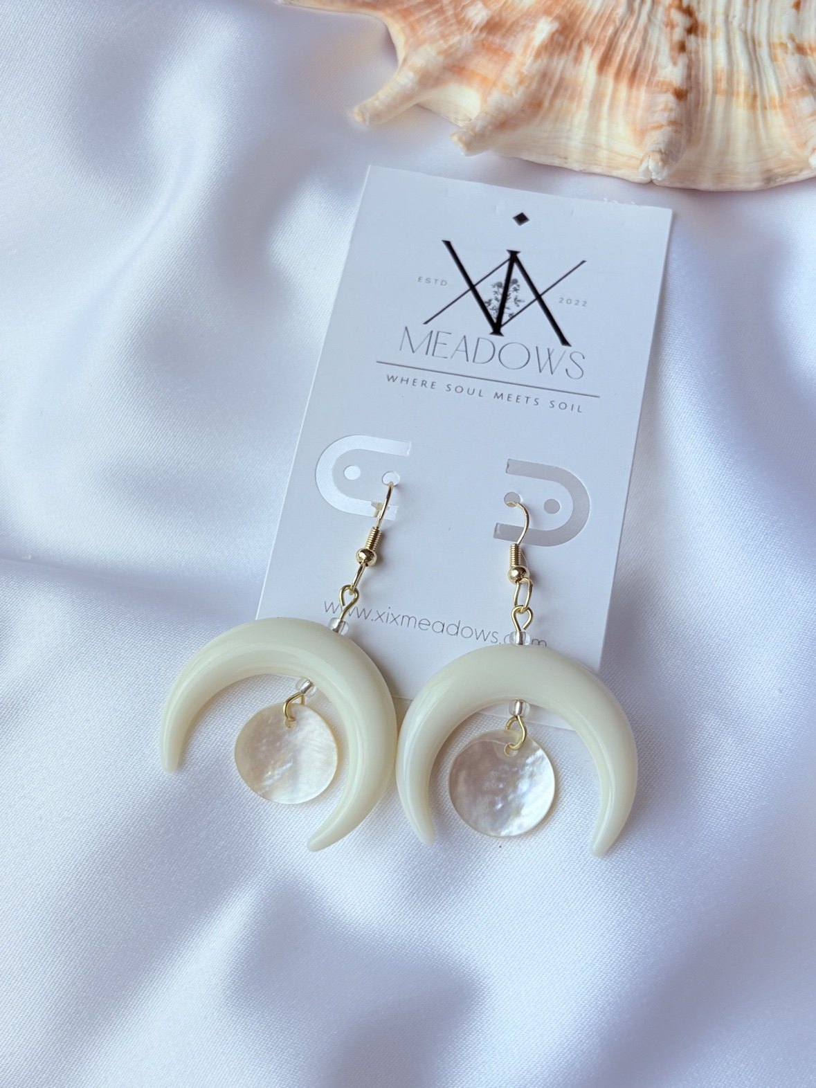 Crescent moon earrings with mother-of-pearl drops on a XiX Meadows card