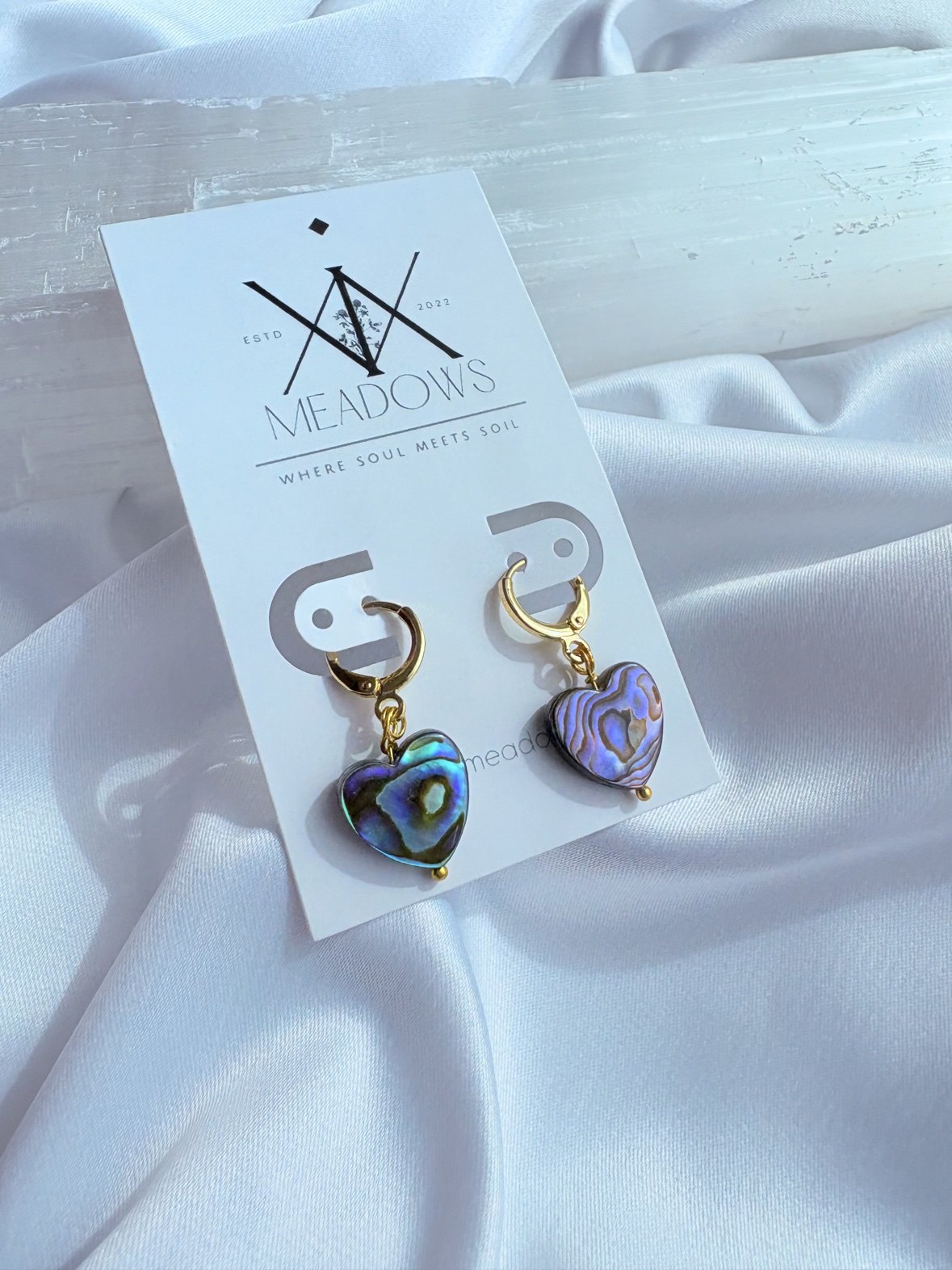 Abalone heart huggie earrings on a XiX Meadows card