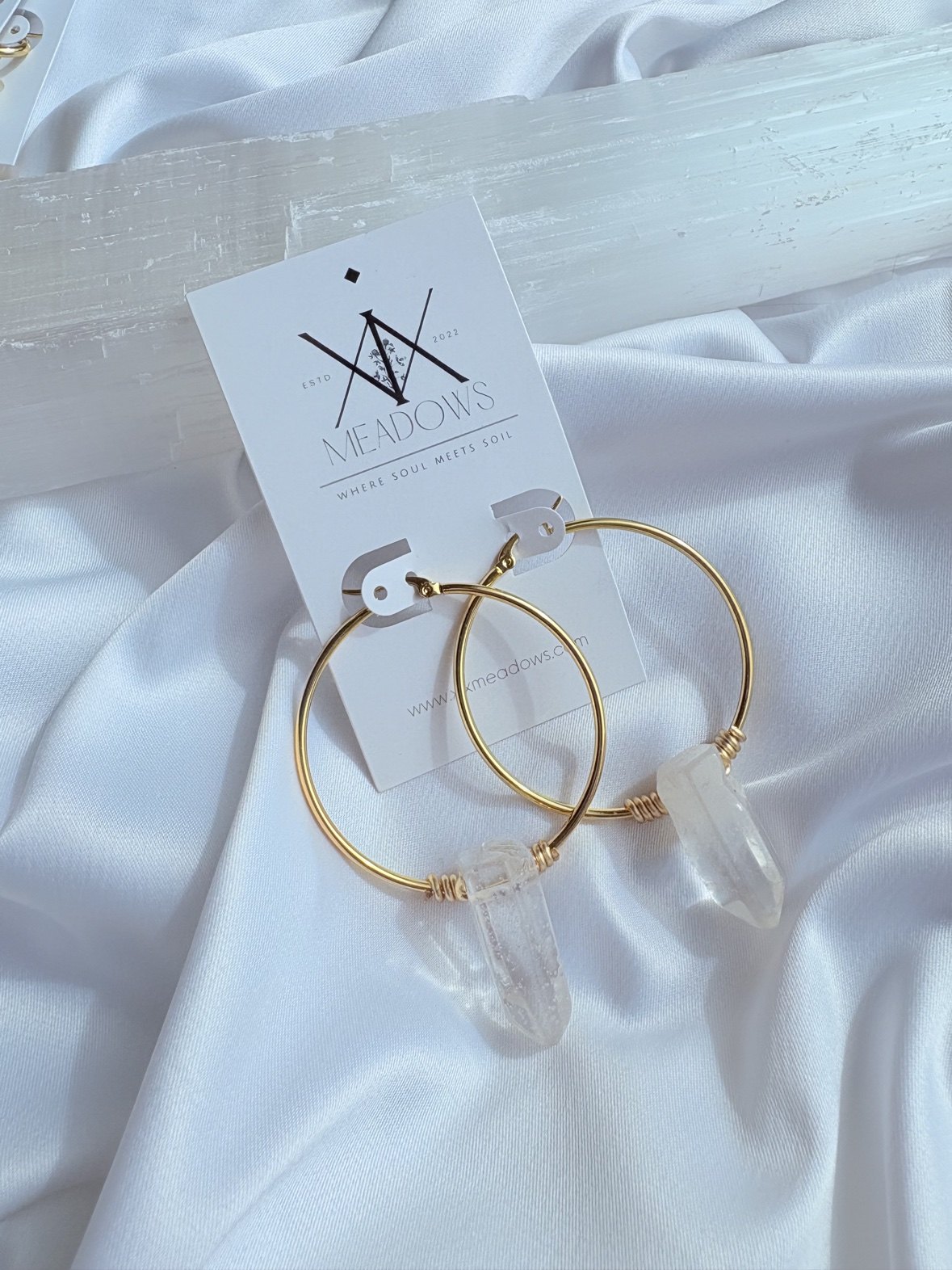Gold hoop earrings with wire-wrapped quartz points on a XiX Meadows card