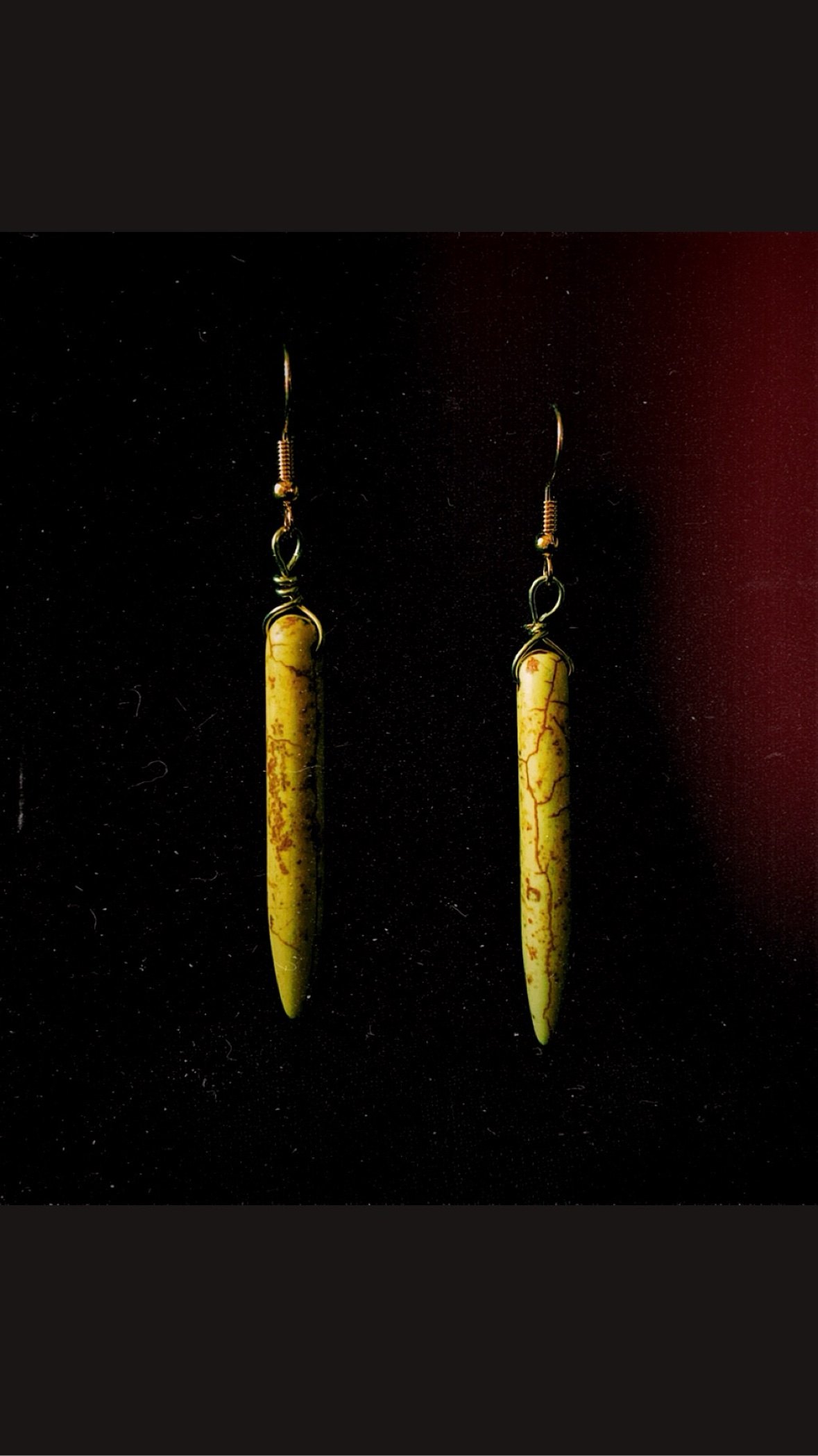 Yellow stone spike earrings photographed on black