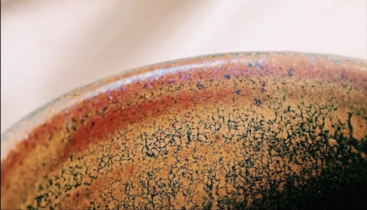Close-up of a crazed tenmoku glaze on a fired piece