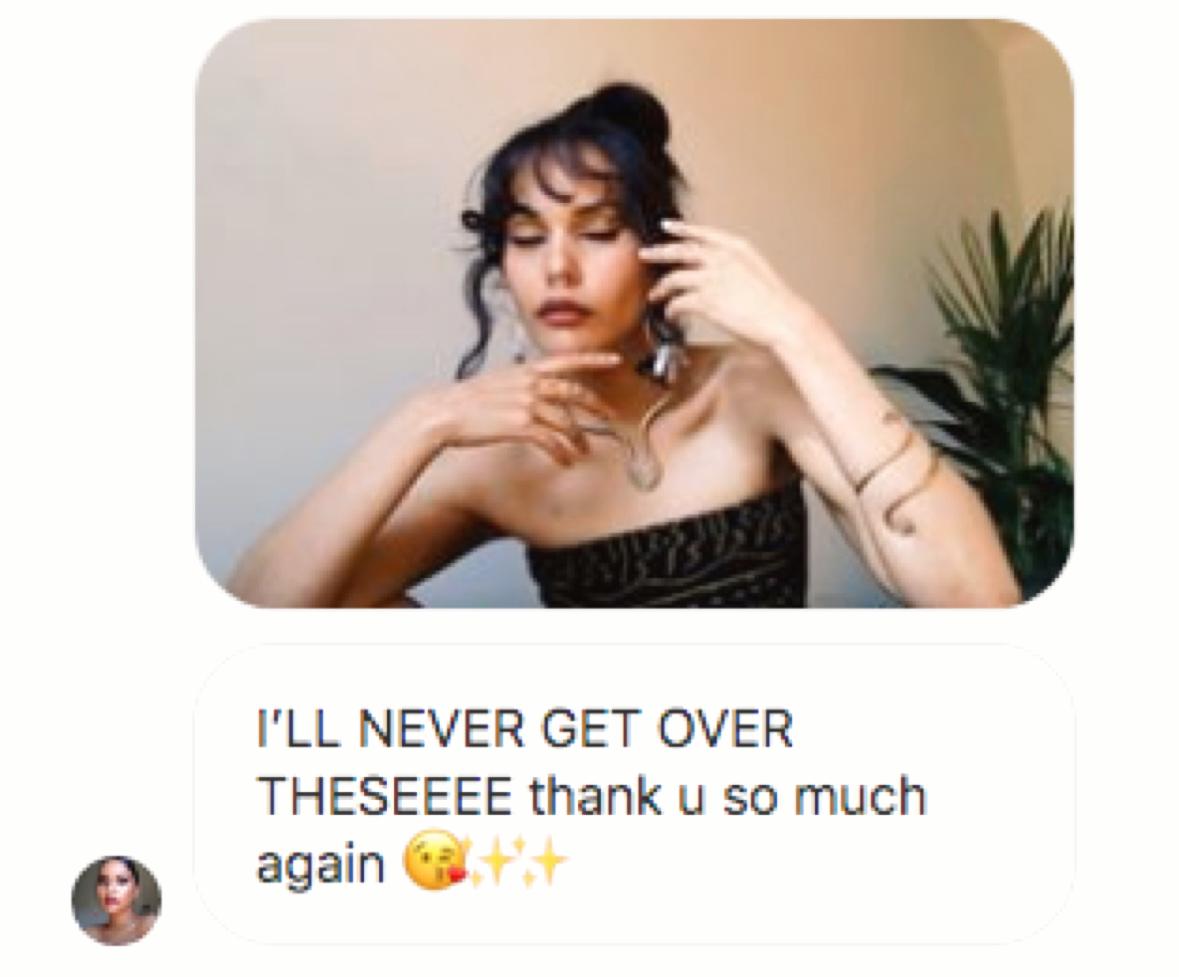 Customer selfie wearing a handmade arm cuff and long stone pendant necklace, above their message: “I'LL NEVER GET OVER THESEEEE thank u so much again”